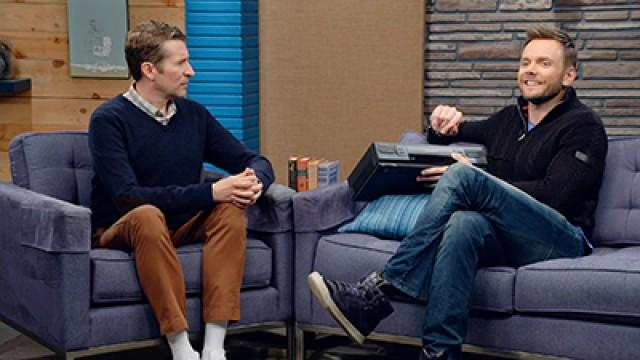 Joel McHale Wears a Navy Zip-Up and High Tops