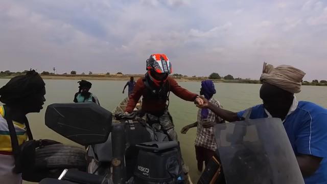 River crossing with motorcycle to enter SENEGAL