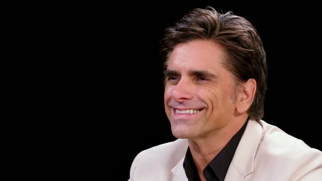 John Stamos Falls Out of His Chair While Eating Spicy Wings